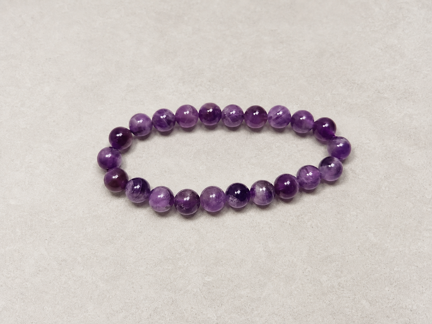 Top view of a purple amethyst bracelet showing its circular bead arrangement.
