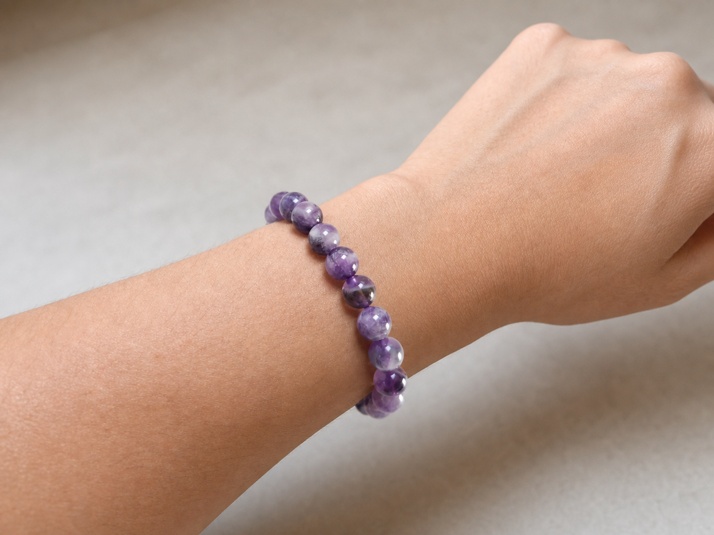 Purple amethyst bracelet worn on a wrist for everyday styling.