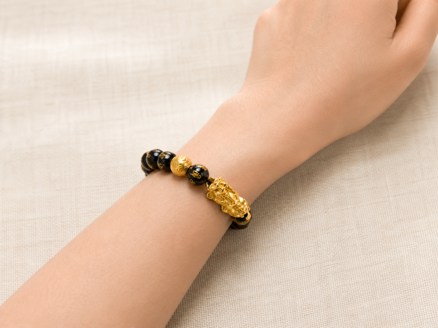 Pixiu black obsidian bracelet worn on the wrist in soft natural light.