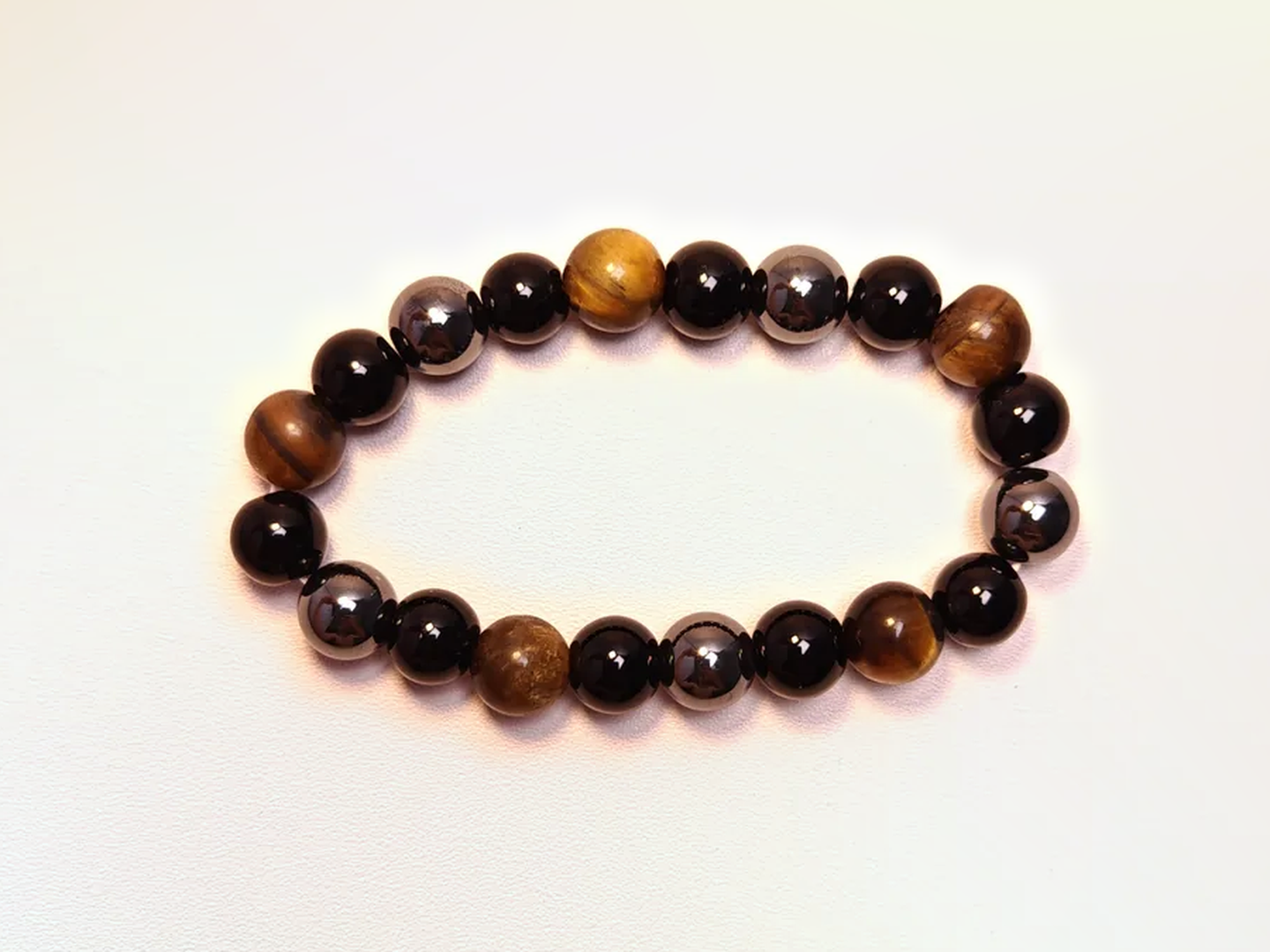 Tiger eye, black obsidian and hematite bracelet in a full product view.