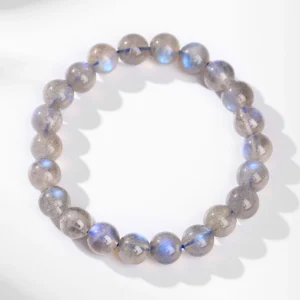 Gray moonstone bracelet with 7-8mm round beads on a white surface