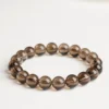 Single-strand smoky quartz bead bracelet on a light surface