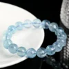 Ice-blue aquamarine bead bracelet shown on a light surface