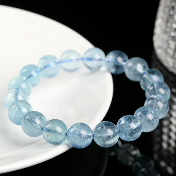 Ice-blue aquamarine bead bracelet shown on a light surface
