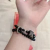Double-wrap silver obsidian lion bracelet worn view