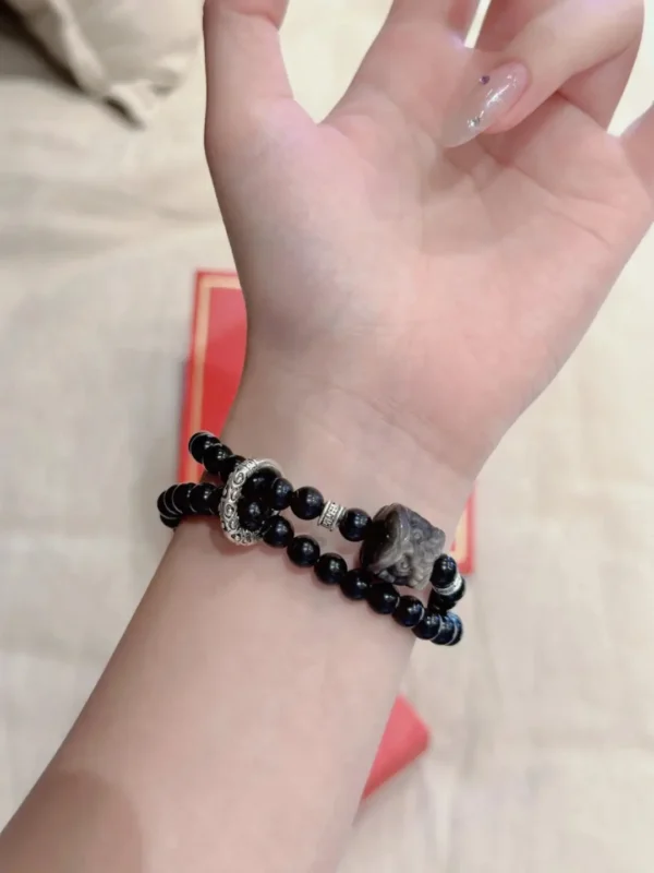 Double-wrap silver obsidian lion bracelet worn view